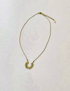 Thunderbird pendant chain necklace displayed on wooden slab with serape fabric underneath - The Wild J