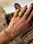 Thunderbird pendant chain necklace displayed on wooden slab with serape fabric underneath - The Wild J