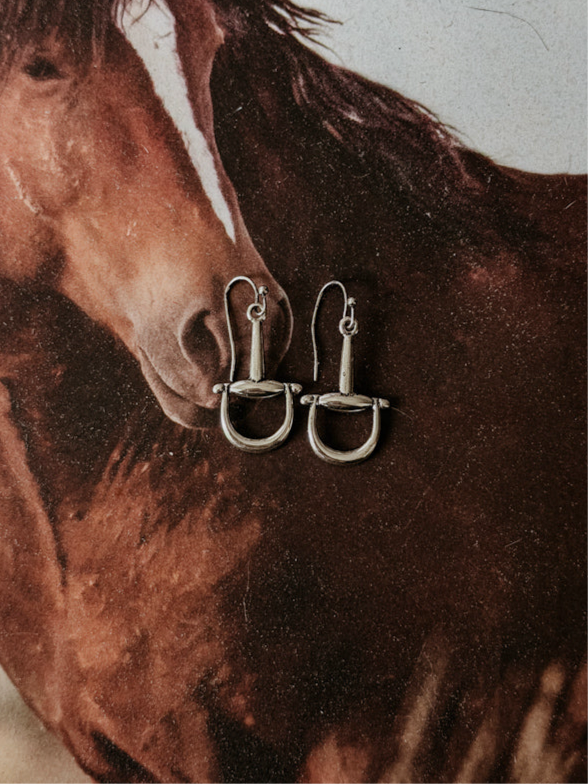 Silver western stirrup earrings on a horse background, cowgirl jewelry accessory