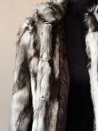 Brown and white faux fur western jacket with toggle closures on a mannequin