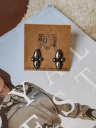 Burnished silver shield-shaped stud earrings featuring bubble accent detailing