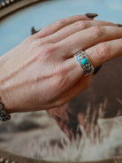 Hand wearing a silver southwestern turquoise ring, boho western jewelry style