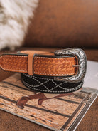 Western tooled leather belt with engraved silver buckle on magazine, boho cowgirl accessory
