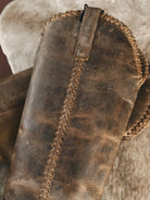 Thunderbird pendant chain necklace displayed on wooden slab with serape fabric underneath - The Wild J