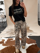 Thunderbird pendant chain necklace displayed on wooden slab with serape fabric underneath - The Wild J