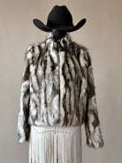 Western faux fur jacket with fringe skirt and black cowboy hat, boho rodeo outfit