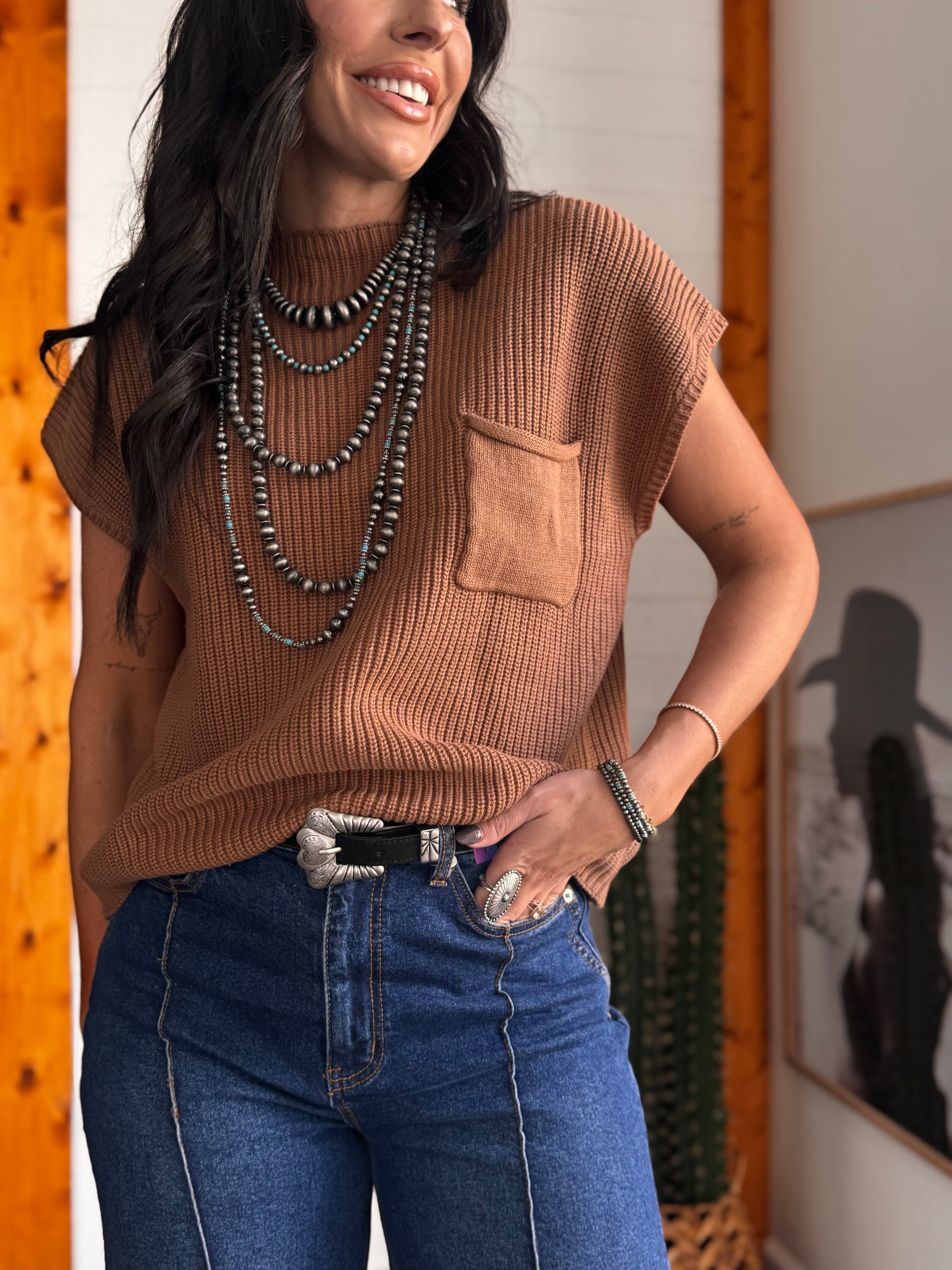 Thunderbird pendant chain necklace displayed on wooden slab with serape fabric underneath - The Wild J