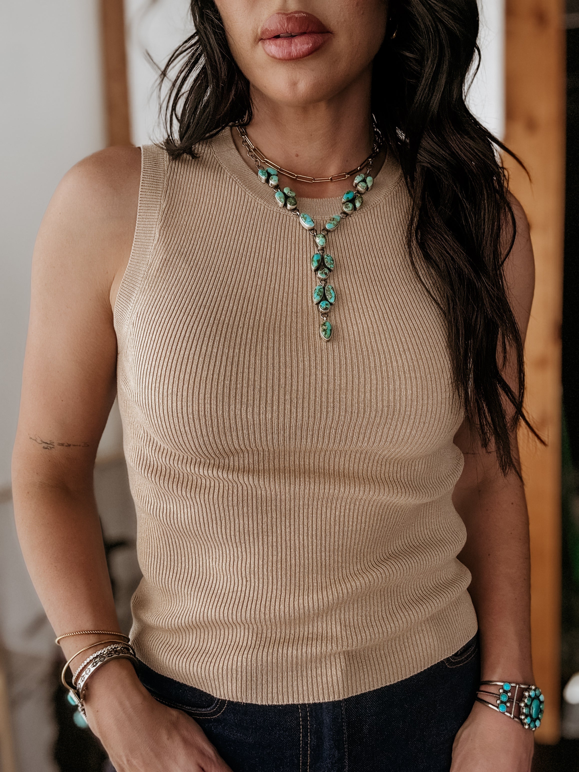 Thunderbird pendant chain necklace displayed on wooden slab with serape fabric underneath - The Wild J