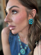 Woman wearing turquoise western earrings, necklace and ring, styled in boho cowgirl fashion