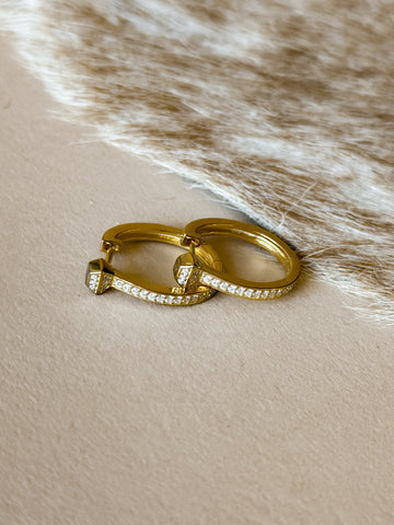 Two gold earrings with cz accents