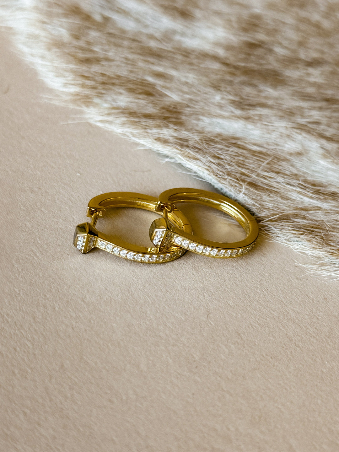 Two gold earrings with cz accents