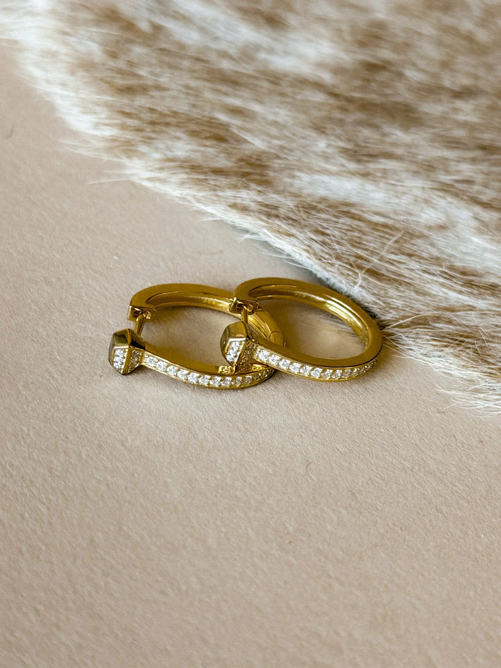 Two gold earrings with cz accents