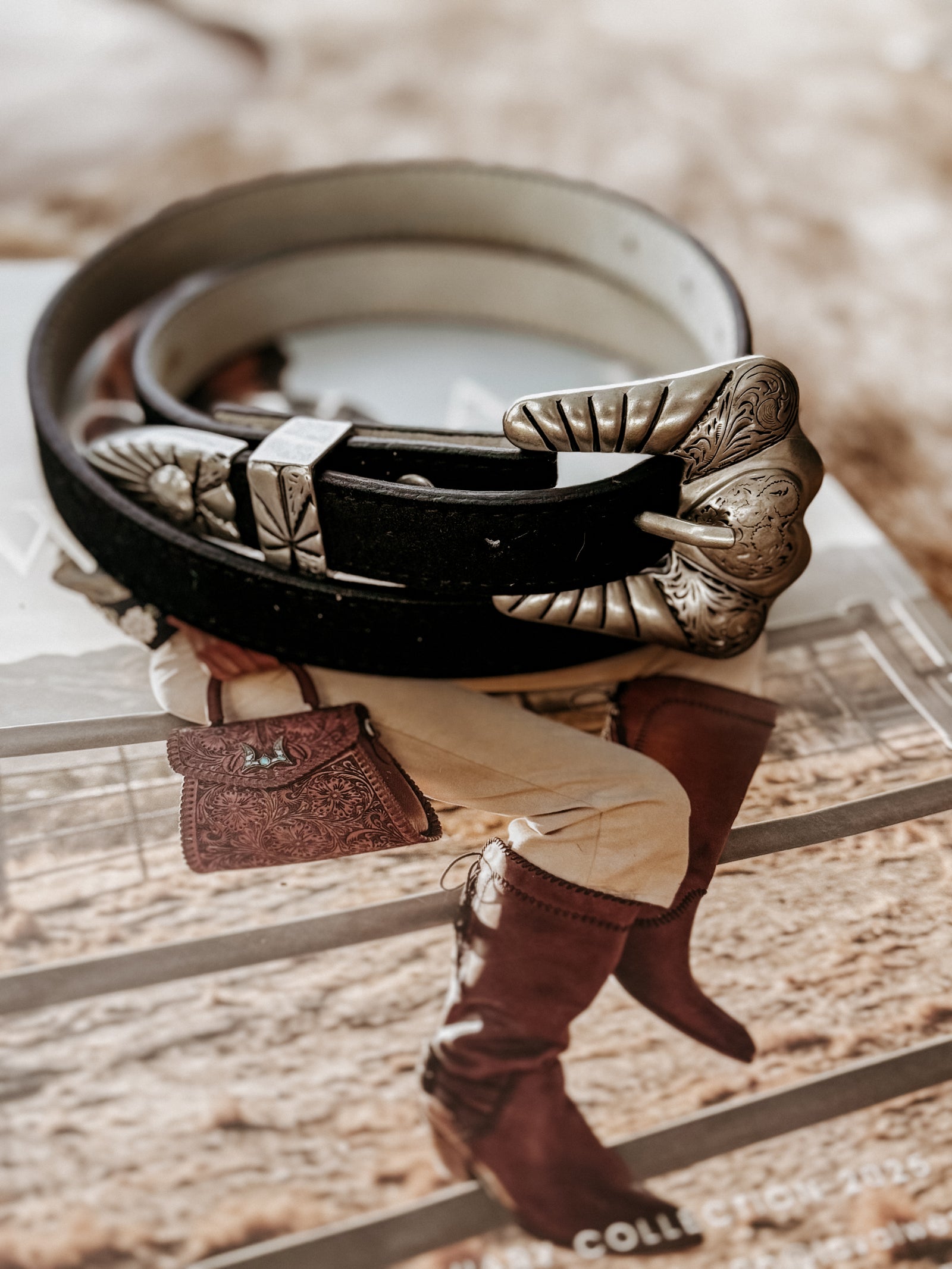 Genuine leather belt with stitched edges, featuring a matte silver-tone engraved heart buckle set including buckle, keeper, and tip.  engraved details throughout.