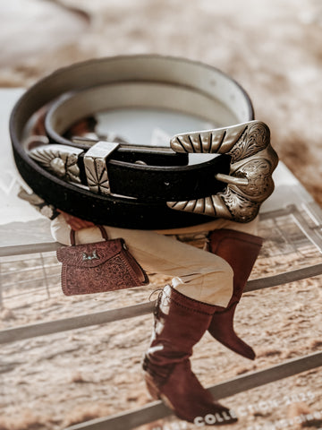 Genuine leather belt with stitched edges, featuring a matte silver-tone engraved heart buckle set including buckle, keeper, and tip.  engraved details throughout.