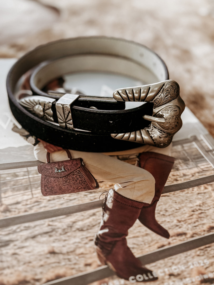 Genuine leather belt with stitched edges, featuring a matte silver-tone engraved heart buckle set including buckle, keeper, and tip.  engraved details throughout.