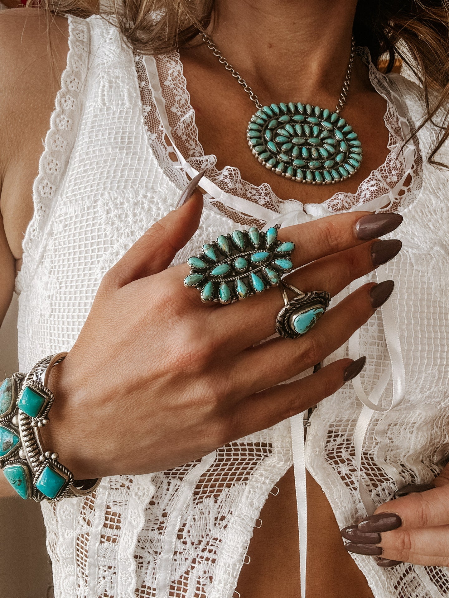 Woman wearing adjustable Silverton Kingman turquoise ring with sterling silver details