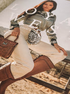 Thunderbird pendant chain necklace displayed on wooden slab with serape fabric underneath - The Wild J