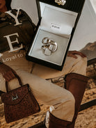 Chunky silver western ring in a jewelry box, price tag $125, on cowgirl fashion magazine.