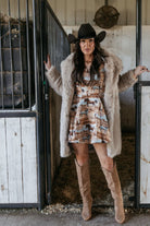 Thunderbird pendant chain necklace displayed on wooden slab with serape fabric underneath - The Wild J