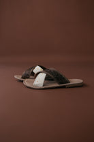 Thunderbird pendant chain necklace displayed on wooden slab with serape fabric underneath - The Wild J