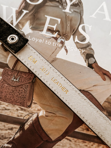 Genuine leather belt with stitched edges, featuring a matte silver-tone engraved heart buckle set including buckle, keeper, and tip.  engraved details throughout.