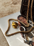 Thunderbird pendant chain necklace displayed on wooden slab with serape fabric underneath - The Wild J