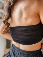 Thunderbird pendant chain necklace displayed on wooden slab with serape fabric underneath - The Wild J