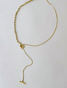 Thunderbird pendant chain necklace displayed on wooden slab with serape fabric underneath - The Wild J