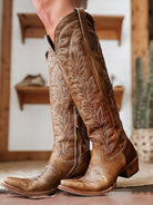 Tall brown leather cowgirl boots with western embroidery, boho rodeo style footwear
