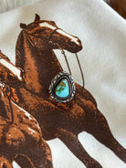 Turquoise western boho ring with silver detailing on a graphic horse print background
