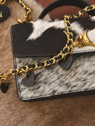 Thunderbird pendant chain necklace displayed on wooden slab with serape fabric underneath - The Wild J