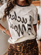 Woman wearing western graphic t-shirt and leopard print skirt, western boho outfit style