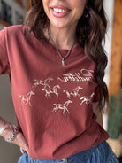 Thunderbird pendant chain necklace displayed on wooden slab with serape fabric underneath - The Wild J