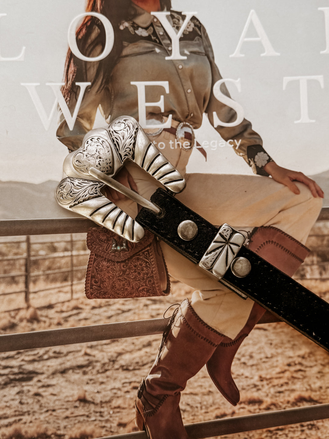 Genuine leather belt with stitched edges, featuring a matte silver-tone engraved heart buckle set including buckle, keeper, and tip.  engraved details throughout.