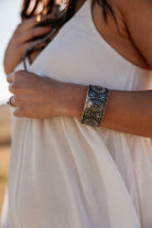 Thunderbird pendant chain necklace displayed on wooden slab with serape fabric underneath - The Wild J