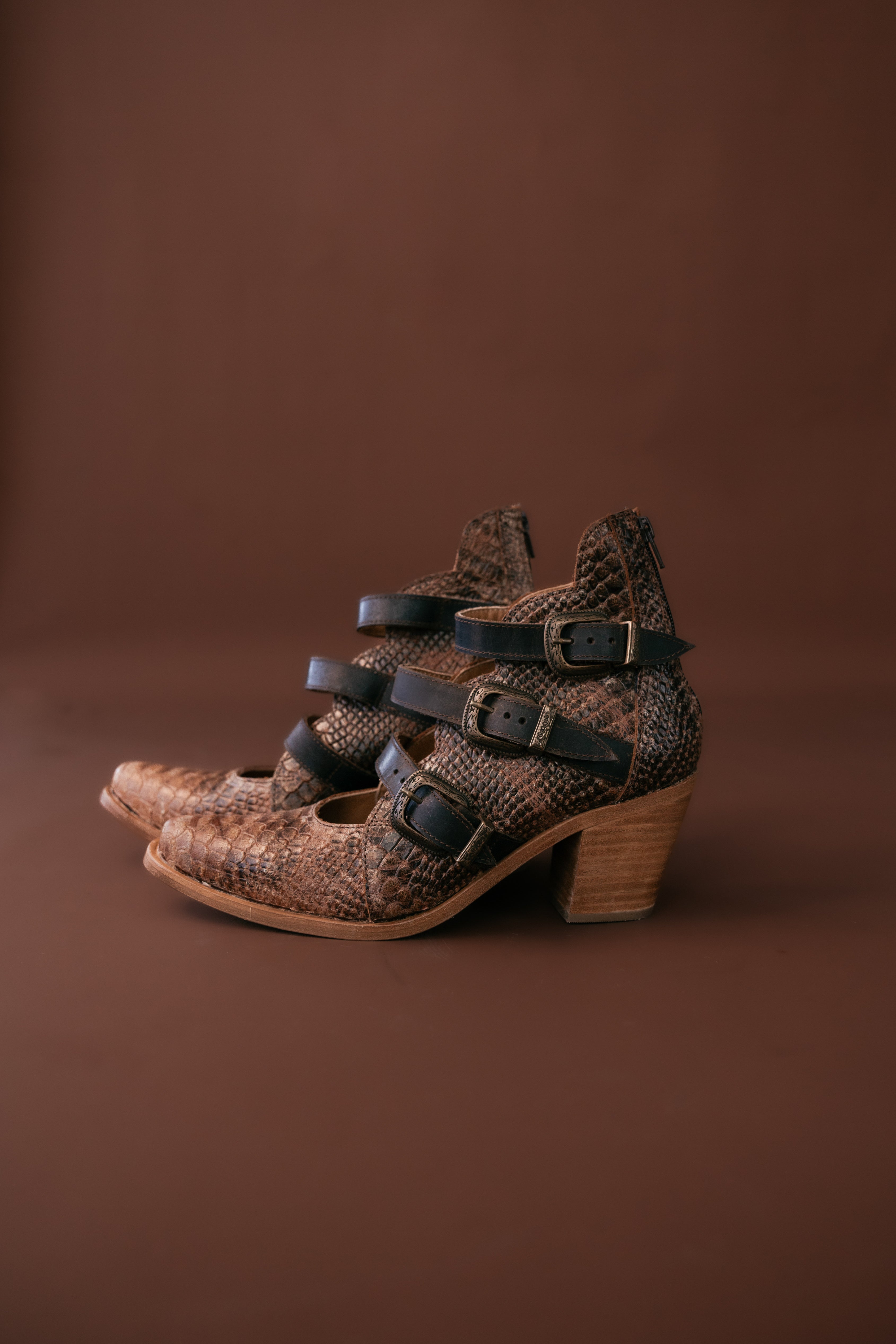 Thunderbird pendant chain necklace displayed on wooden slab with serape fabric underneath - The Wild J