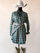 Thunderbird pendant chain necklace displayed on wooden slab with serape fabric underneath - The Wild J