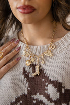 Thunderbird pendant chain necklace displayed on wooden slab with serape fabric underneath - The Wild J