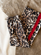 Thunderbird pendant chain necklace displayed on wooden slab with serape fabric underneath - The Wild J