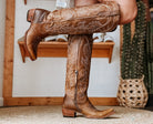Brown tooled leather western cowgirl boots with embroidery, side zipper, and pointed toe