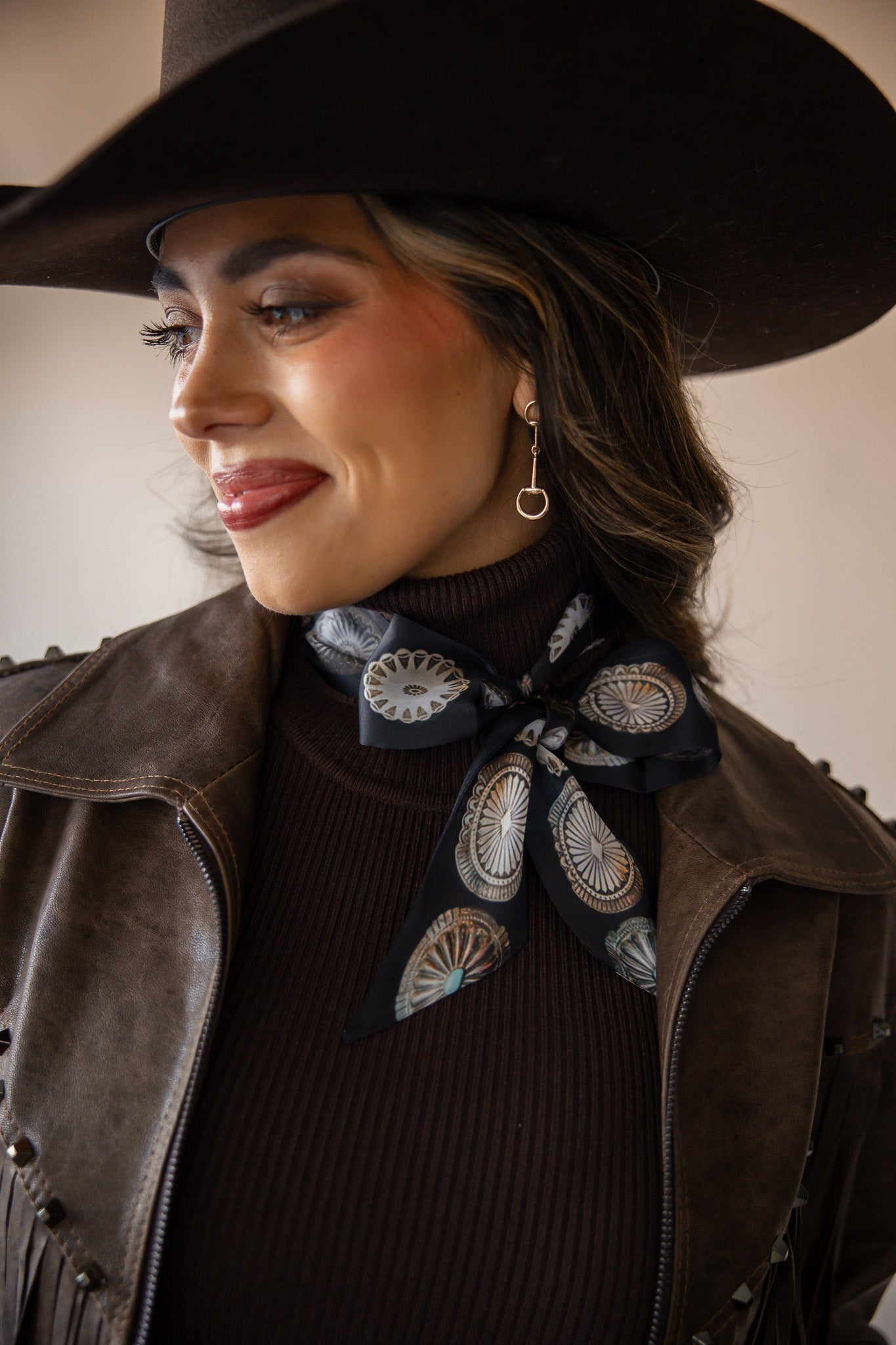 Thunderbird pendant chain necklace displayed on wooden slab with serape fabric underneath - The Wild J