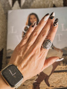 Thunderbird pendant chain necklace displayed on wooden slab with serape fabric underneath - The Wild J