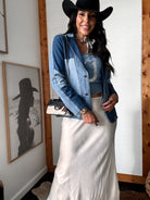 Thunderbird pendant chain necklace displayed on wooden slab with serape fabric underneath - The Wild J