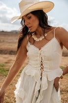 Thunderbird pendant chain necklace displayed on wooden slab with serape fabric underneath - The Wild J