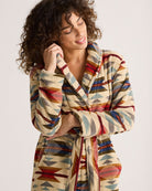 Thunderbird pendant chain necklace displayed on wooden slab with serape fabric underneath - The Wild J