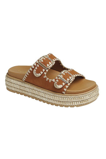 Camel platform sandals featuring two stitched buckle straps with gold adjustable hardware, a braided raffia-style platform, textured sole for added grip, and a soft cushioned insole for comfort.