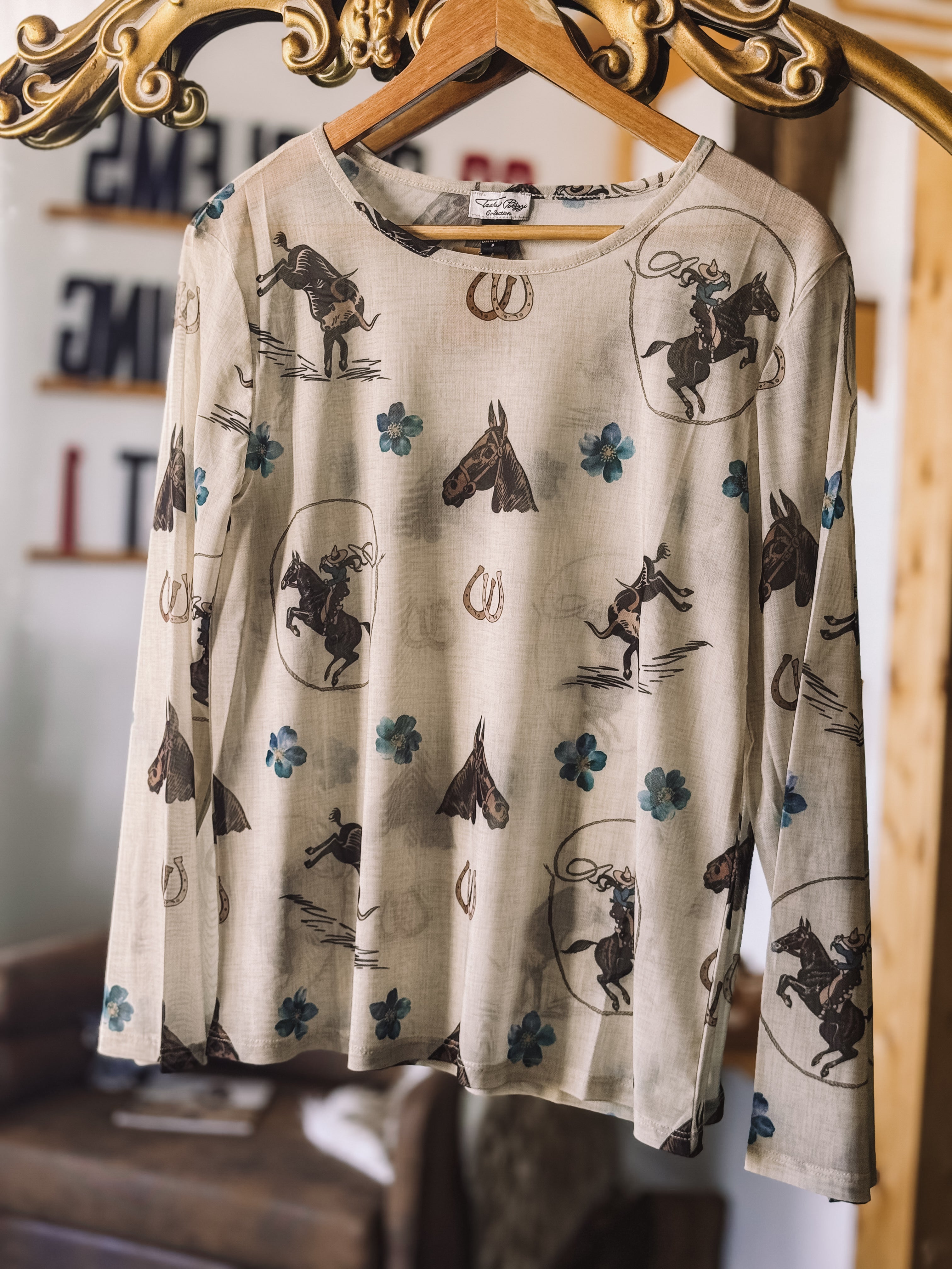 Thunderbird pendant chain necklace displayed on wooden slab with serape fabric underneath - The Wild J