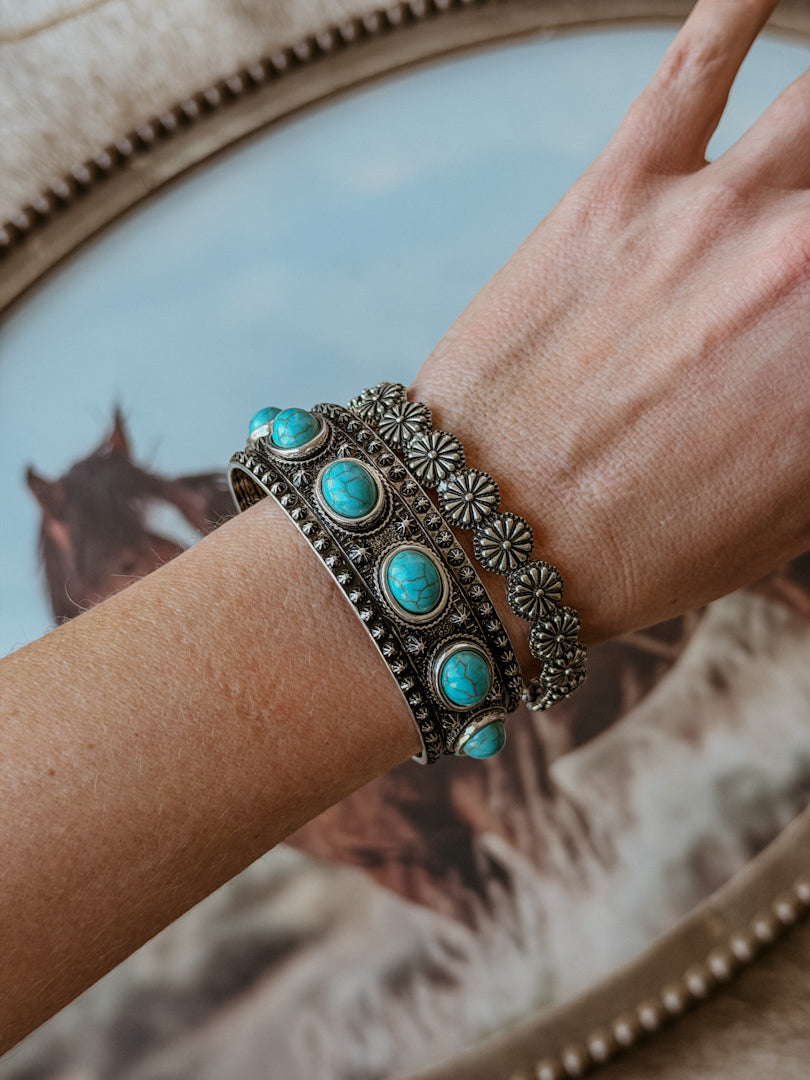 Thunderbird pendant chain necklace displayed on wooden slab with serape fabric underneath - The Wild J