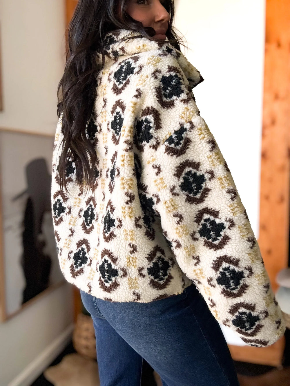 Person wearing a patterned coat with a blurred background