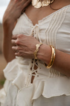 Thunderbird pendant chain necklace displayed on wooden slab with serape fabric underneath - The Wild J